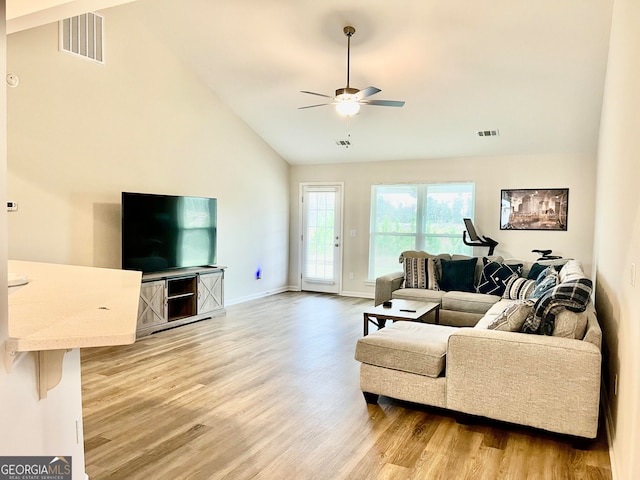 living room with ceiling fan, high vaulted ceiling, and hardwood / wood-style flooring