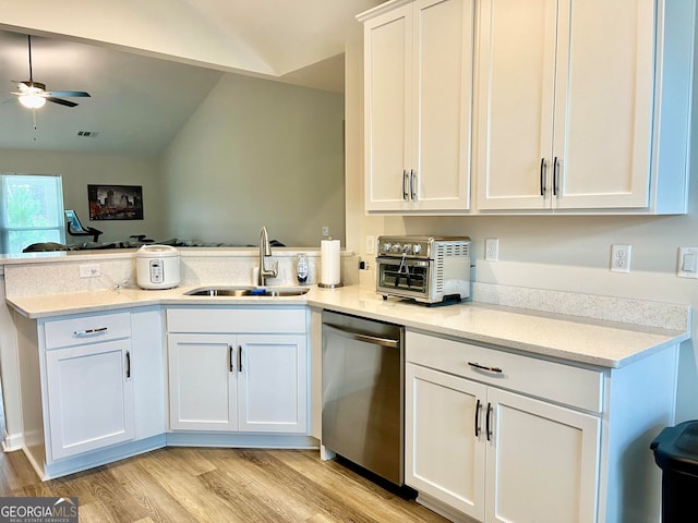 kitchen featuring white cabinets, sink, light hardwood / wood-style flooring, stainless steel dishwasher, and kitchen peninsula