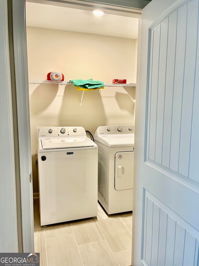 laundry room featuring washing machine and clothes dryer