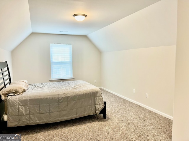 bedroom featuring carpet flooring and lofted ceiling