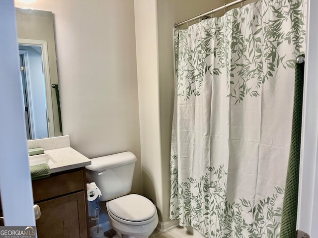 bathroom featuring tile patterned flooring, vanity, and toilet