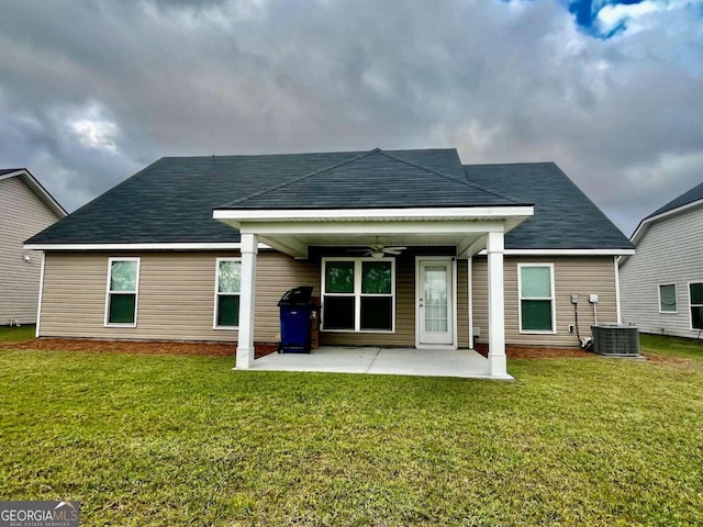 back of house with cooling unit, ceiling fan, a patio area, and a lawn