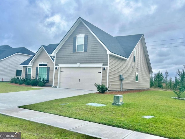 view of front of house with a garage and a front lawn