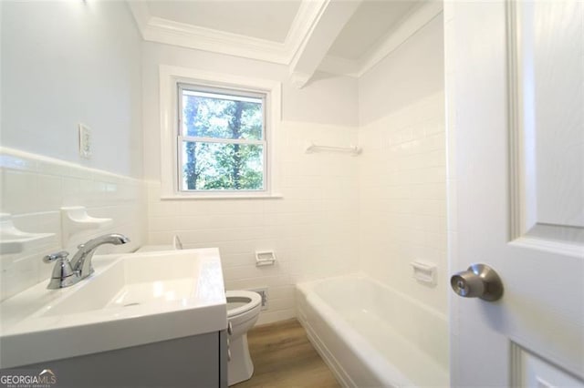 full bathroom with ornamental molding, vanity, wood-type flooring, tile walls, and toilet