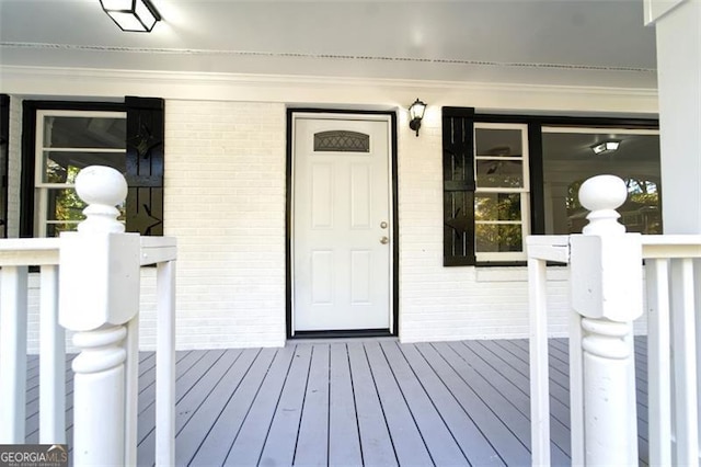 view of exterior entry featuring covered porch