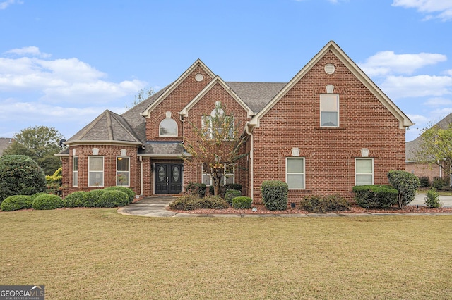 front facade with french doors and a front lawn