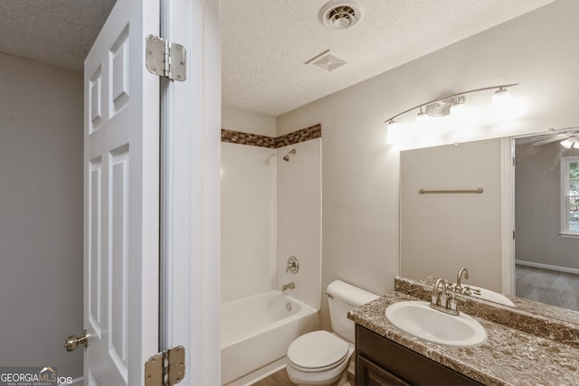 full bathroom with vanity, a textured ceiling, toilet, and shower / washtub combination