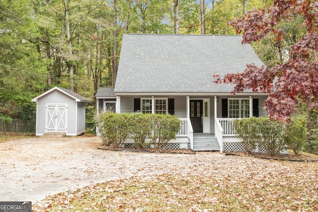 view of front of home featuring covered porch and a storage unit