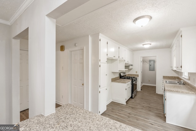 kitchen featuring light hardwood / wood-style flooring, white cabinets, sink, stainless steel range with gas stovetop, and a textured ceiling