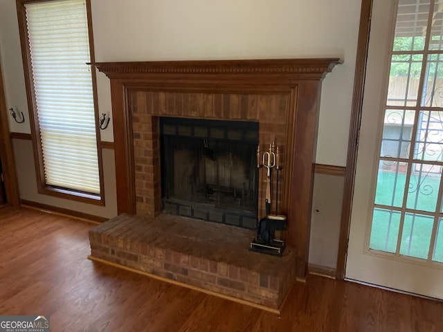 room details featuring hardwood / wood-style flooring and a brick fireplace