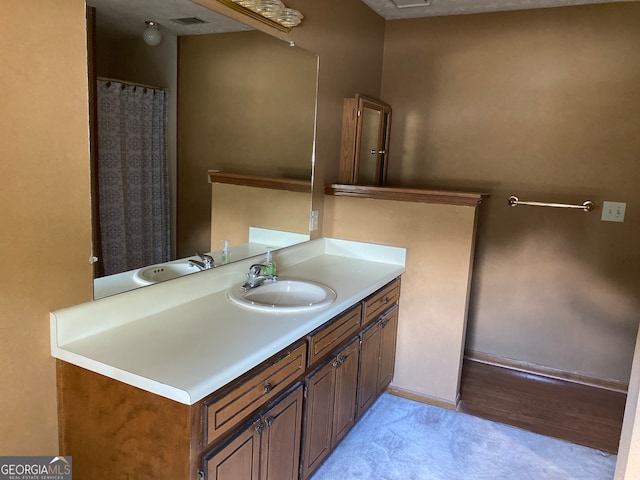 bathroom with vanity and wood-type flooring