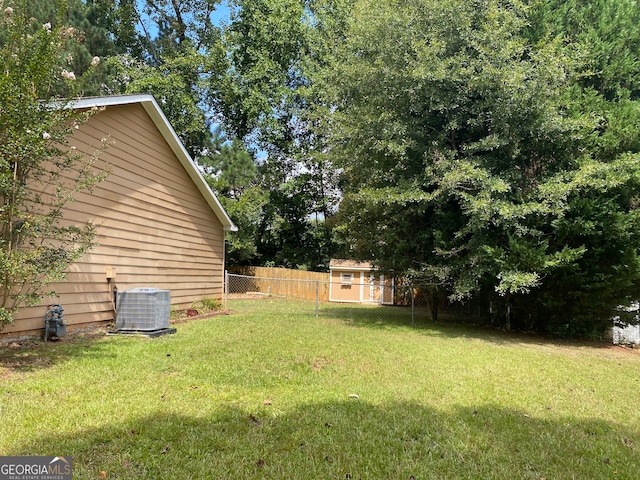 view of yard with central AC unit and a storage shed