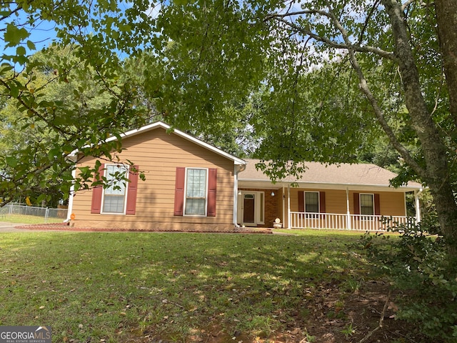 ranch-style house featuring a front lawn and covered porch