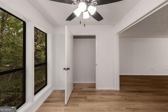 unfurnished bedroom with light hardwood / wood-style flooring and ceiling fan