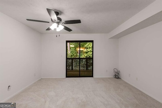 carpeted spare room with ceiling fan and a textured ceiling