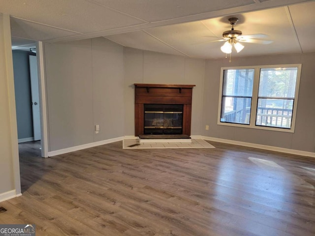 unfurnished living room featuring wood-type flooring and ceiling fan