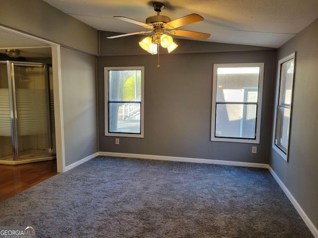 carpeted spare room featuring a textured ceiling and ceiling fan