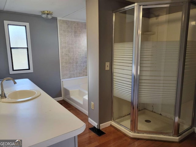 bathroom featuring hardwood / wood-style floors, vanity, and independent shower and bath