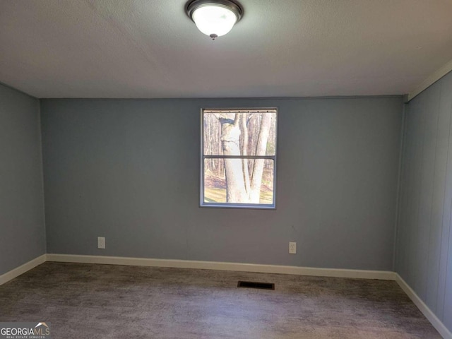 spare room with carpet floors and a textured ceiling