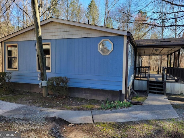 view of side of home with covered porch and a deck