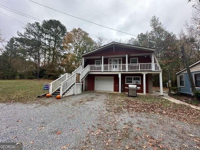 view of front of property featuring covered porch and a garage