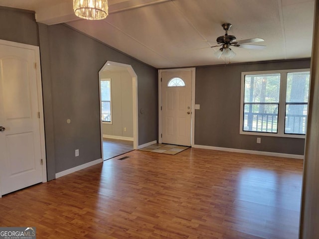 entryway with ceiling fan with notable chandelier, hardwood / wood-style flooring, and a healthy amount of sunlight