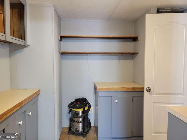 clothes washing area with a textured ceiling