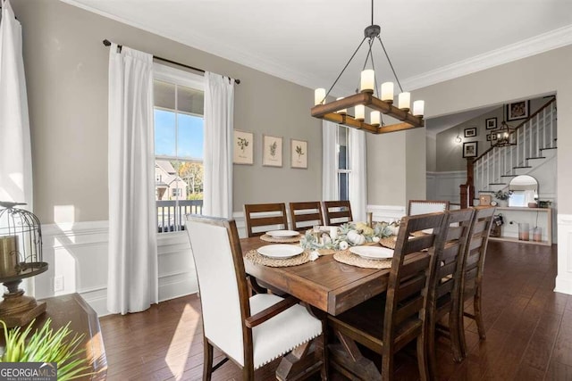 dining room with dark hardwood / wood-style flooring, ornamental molding, and a notable chandelier