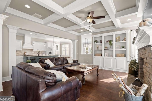 living room featuring decorative columns, dark hardwood / wood-style flooring, beam ceiling, and coffered ceiling