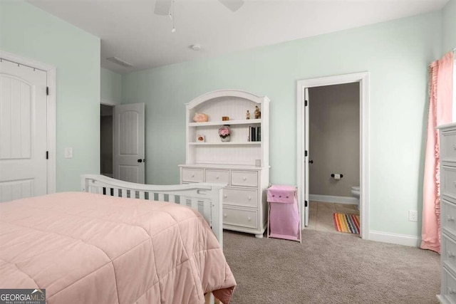 carpeted bedroom featuring ceiling fan and connected bathroom