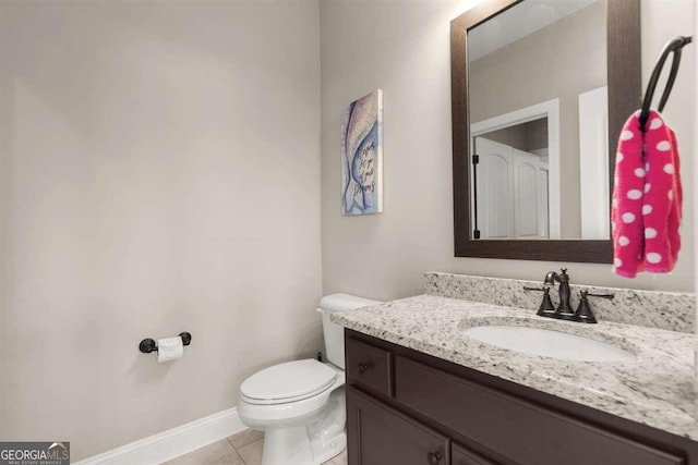 bathroom featuring toilet, tile patterned flooring, and vanity