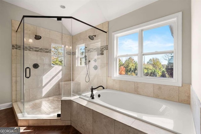 bathroom featuring vaulted ceiling and separate shower and tub