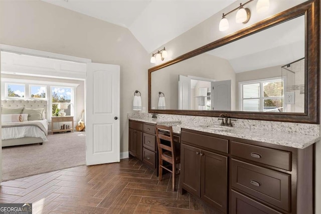 bathroom with vanity, lofted ceiling, and parquet floors