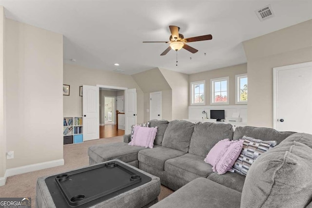 carpeted living room with ceiling fan