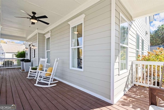 wooden terrace featuring ceiling fan and covered porch