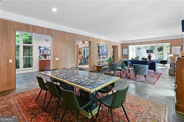 dining room with wooden walls