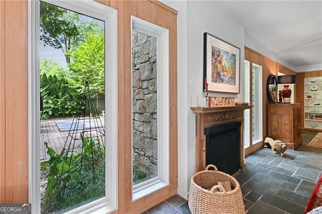 doorway to outside featuring built in shelves and wood walls