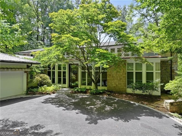 rear view of house featuring a garage