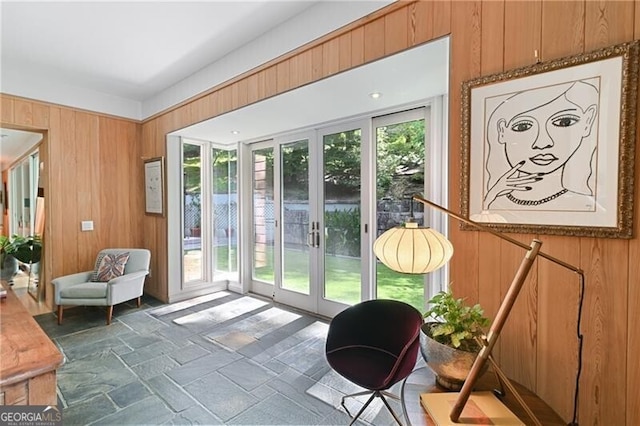 entryway with french doors and wooden walls