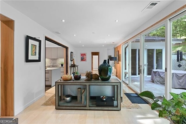 recreation room with light wood-type flooring