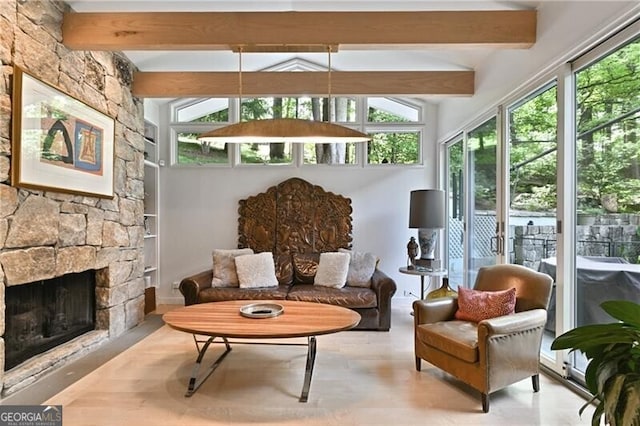 sunroom with beam ceiling and a fireplace