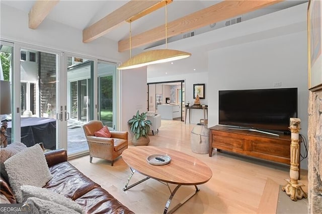 living room featuring vaulted ceiling with beams, light hardwood / wood-style flooring, and french doors