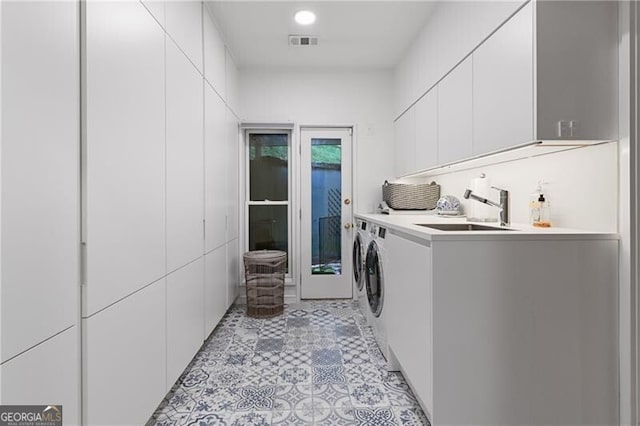 laundry room featuring sink, cabinets, and independent washer and dryer