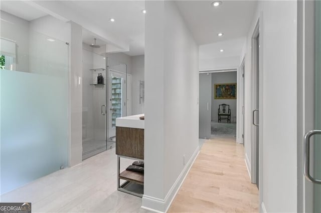 hallway with light hardwood / wood-style flooring