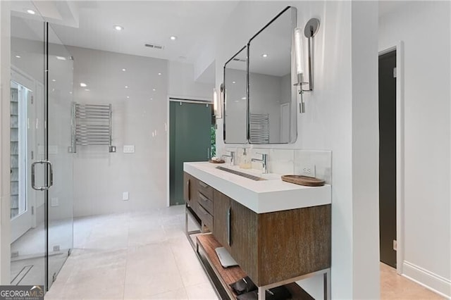 bathroom with tile patterned flooring, decorative backsplash, a shower with door, and vanity