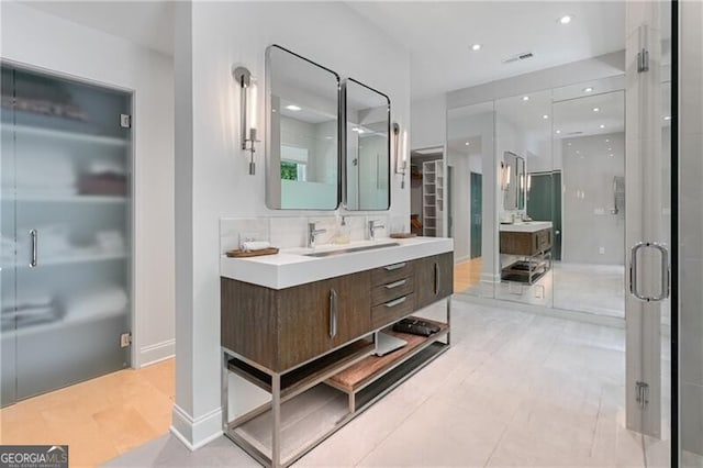 bathroom with decorative backsplash, an enclosed shower, and vanity