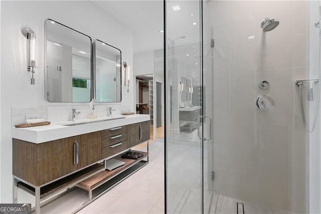 bathroom featuring vanity, backsplash, and an enclosed shower