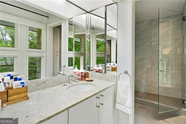 bathroom featuring vanity, tile patterned floors, and walk in shower