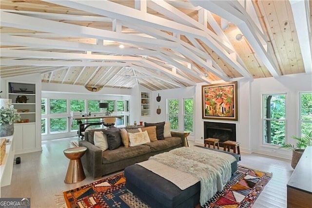 sunroom with plenty of natural light and lofted ceiling with beams