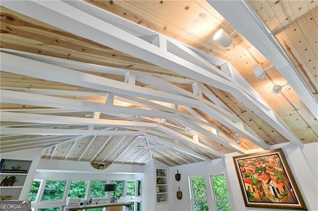 interior details with built in shelves, beamed ceiling, and wood ceiling